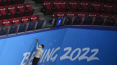 A worker prepares the apron of the arena during practice at the Wukesong Sports Centre. Getty