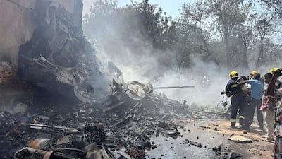 Firefighters work at the site of the Air India Flight 171 crash in Ahmedabad in Gujarat, India. AP