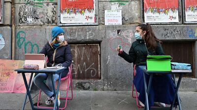 Anita Iacovelli (left) and her friend Lisa Rogliatti, both aged 12, sit in front of the Italo Calvino school in Turin as they protest against no school from the seventh grade up because of government restrictions due to the Covid-19 pandemic. Italy has shut some schools, bars, restaurants and shops in the worst-affected areas and introduced a 10pm-5am nationwide curfew, but has so far swerved a second shutdown, with fast antigen tests becoming a crucial part of its efforts. AFP