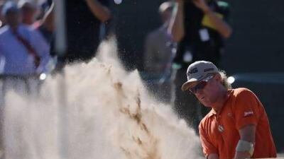 Just like a day at the beach for Miguel Angel Jimenez of Spain, who plays out of a bunker on the 18th hole. Jimenez carded a 71 for a two-day total of 139 at the British Open on Friday.