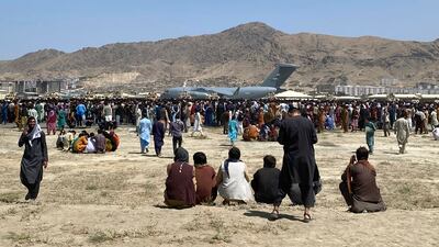 Hundreds of people gather at the perimeter of the international airport in Kabul on August 16, 2021. AP