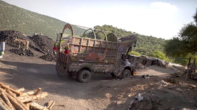 A truck drives past a coal field in Choa Saidan Shah, Punjab. Sara Farid / Reuters