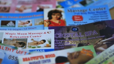 Flyers advertising massages are being handed out to residents walking around Abu Dhabi and are being put on parked cars in the capital. Ravindranath K / The National