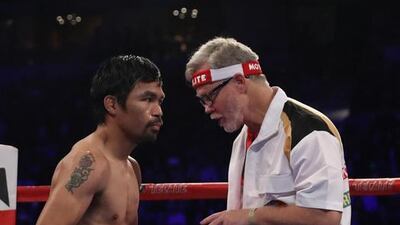 Manny Pacquiao of the Philippines and trainer Freddie Roach stand in the ring. Christian Petersen / Getty Images
