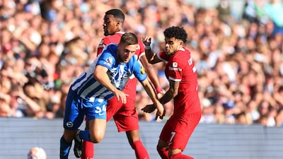 Liverpool's Luis Diaz and Ryan Gravenberch fight for the ball with Brighton & Hove Albion's Joel Veltman. Reuters