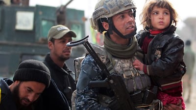 Iraqi forces evacuate civilians fleeing Mosul's eastern Al Intisar neighbourhood. Ahmad Al Rubaye / AFP