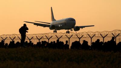 An airplane lands at the Vaclav Havel airport as plane spotters wait for the departure of Antonov An-225 Mriya. David W Cerny / Reuters