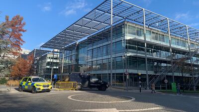 An armoured police vehicle and a police response car parked outside Iran International's newsroom in west London. The National