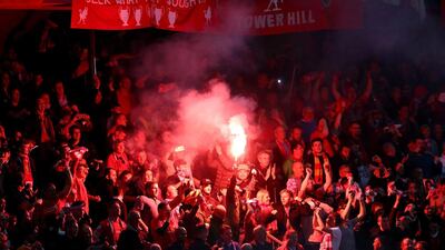 Liverpool supporters light a firework during the Europa League final at St Jakob-Park. Michael Steele/Getty Images