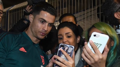Cristiano Ronaldo signs autographs and poses for selfies before the training session in Riyadh. Getty