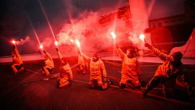 French skipper Alexia Barrier and members of her crew hold lit flares to celebrate completing the Jules Verne Trophy, at Brest harbour, Brittany, France. The Famous Project team became the first all-female crew to complete the non-stop round-the-world voyage in a maxi-trimaran, her team announced. AFP