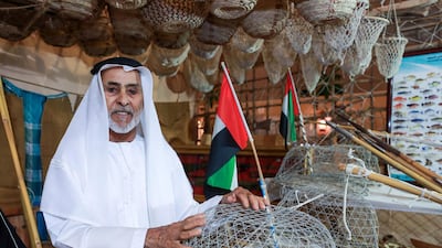 Abu Dhabi, U.A.E., July 18, 2018. First day of the 2018 Liwa Date Festival. -- Jumaa Hathbour Al Romaithi proudly shows of his Emirati Heritage collection of fishing tools, old coins, knives, picture frames and other collectors items. Victor Besa / The National Section: NA Reporter: Haneen Dajani