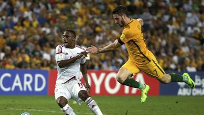 The UAE’s Ahmed Khalil, left, and Australia’s Mathew Leckie compete for the ball. Rick Rycroft / AP Photo