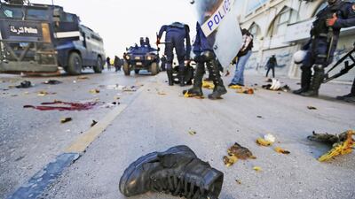 The boot of a riot-police official lies on the road at the scene where a homemade bomb exploded during clashes. Sheikh Saif bin Zayed, Deputy Prime Minister and Minister of Interior, denounced the bomb attack and stressed the importance of fighting terrorism. Hamad I Mohammed / Reuters