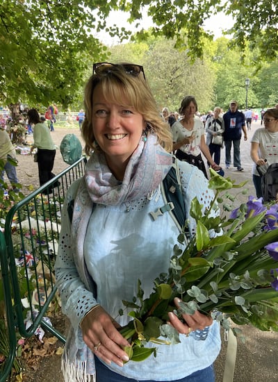 Sue Tovey at the floral tribute area in Green Park. PA
