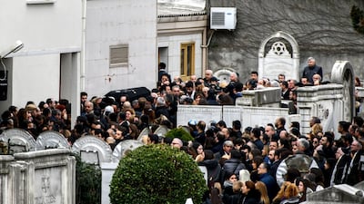 A crowd gathers as Ms Hananel's coffin is carried through the Arnavutkoy Jewish cemetery in Istanbul. Stringer / AFP Photo.
