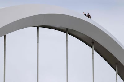 Protester Guido Reichstadter stands on the Frederick Douglass Memorial Bridge. Getty Images via AFP