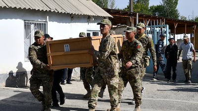 Kyrgyzstan servicemen carry a coffin with the body of a soldier in Batken, south-western Kyrgyzstan. AP