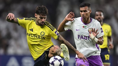 Nassr's Samu Costa and Houssine Rahimi of Al Ain battle for possession. AFP