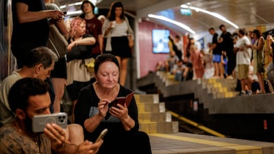 People take shelter at a station of the Carmelit underground funicular railway in Israel's northern city of Haifa. AFP