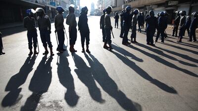 Members of ZRP block the road to contain the planned peace march. EPA