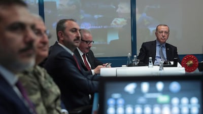 Turkey's President Recep Tayyip Erdogan, right, with military and Intelligence chiefs, ministers and his ruling party members in an operations room at the presidential palace, in Ankara, Turkey, on Wednesday, October 9, 2019. Turkish Presidency Press Service via AP