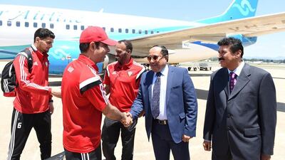 UAE coach Mahdi Ali, red hat, greets dignitaries in Canberra, Australia as the UAE national football team arrive on Wednesday in the city for their first 2015 Asian Cup game on Sunday.