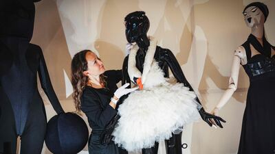 Head of exhibitions at the Design Museum Elise Foster Vander Elst arranges the 'swan dress' designed by Marjan Pejoski and worn by Icelandic singer Bjork at the 2001 Oscars during the preview of the exhibition Rebel: 30 Years of London Fashion at the Design Museum, in London. AFP