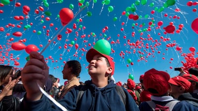 Children release balloons in the air during activities for World Children's Day at the Jemaa el-Fna square in Marrakech. AFP