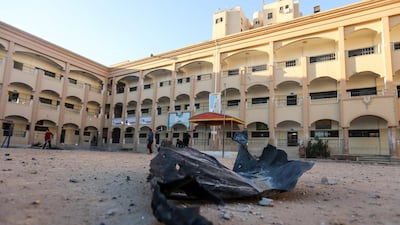 Palestinians clean up debris at a school in the aftermath of an Israeli air strike in Beit Lahia, in the northern Gaza Strip. Mahmud Hams / AFP Photo.