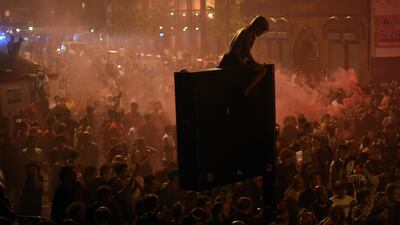 Fans celebrate Liverpool winning the Premier League title outside Anfield stadium following Chelsea's 2-1 victory over Manchester City. AFP