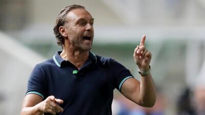 APOEL coach Thomas Doll speaks to his players. AFP