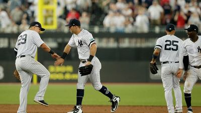 From left, New York Yankees' Gio Urshela, DJ LeMahieu, Gleyber Torres and Didi Gregorius celebrate after defeating the Boston Red Sox in a baseball game, in London. Major League Baseball made its European debut game Saturday at London Stadium. AP