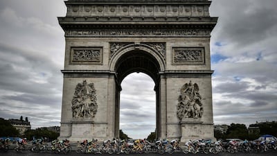 The pack rides past the Arc de triomphe monument. AFP