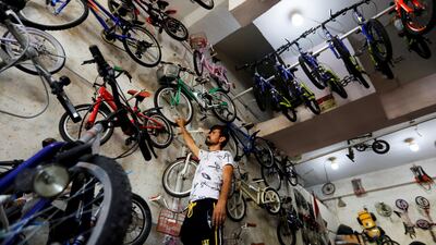 A man checks a bicycle at a shop in Baghdad, Iraq. REUTERS