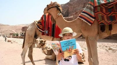 The writer's son, Benjamin, reads a Tintin adventure in Petra, Jordan.