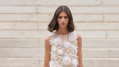 At Chanel, a white bridal gown was made with fragile tiers and hand-applied feathers for haute couture autumn / winter 2021.