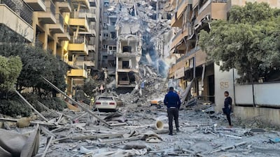 People look at the damage caused by an Israeli strike in Tyre, southern Lebanon. AFP