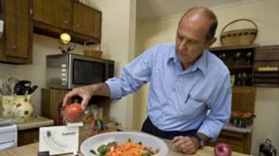 Bob Cavanaugh, who has followed the Calorie Restriction Diet for eight years, prepares a healthy meal in his kitchen.
