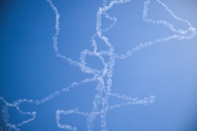 Vapor trails from interception of Iranian missiles. Reuters