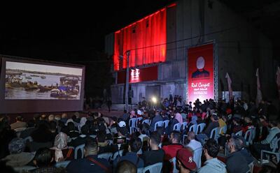 Palestinians watch 'Gaza' during the opening ceremony of the Red Carpet Human Rights Film Festival in Palestine, in front of the abandoned Cinema Amer building in Gaza City, on Wednesday, December 4, 2019. AFP
