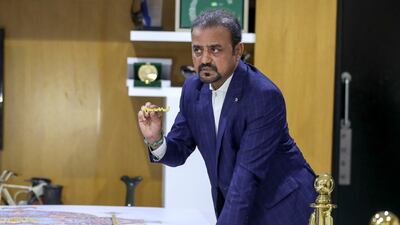 Artist Shahid Rassam describes how the calligraphy is crafted from gold-plated aluminium. Khushnum Bhandari / The National