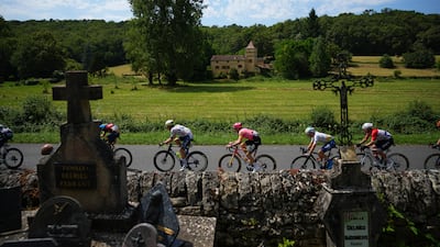 Riders passing a cemetery during Stage 12 of the Tour de France. AP