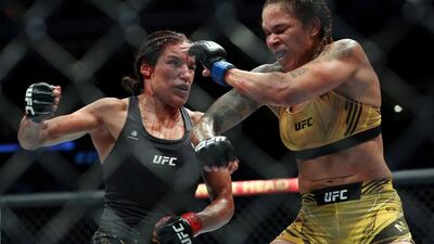 Julianna Pena and Amanda Nunes trade strikes during their bantamweight title bout at UFC 277. AP