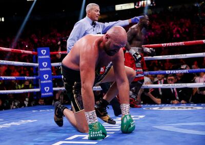 Tyson Fury is knocked down by Deontay Wilder in the fourth round. AP Photo