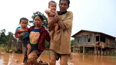 A family flees their home after the Xepian-Xe Nam Noy hydropower dam collapsed in , Laos July 26, 2018. Reuters