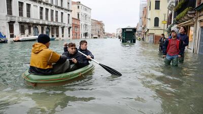 epa07999375 People row a small boat in high water in Venice, northern Italy, 15 November 2019. Venice closed St Mark's Square due to fresh flooding in the city. The city is currently suffering its second-worst floods on record, with the high-water mark reaching 187cm on Tuesday. The water level had dropped down significantly but it is forecast to go back up to 160cm today. EPA/ANDREA MEROLA