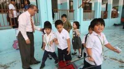 Daniel Sistona, the principal of Pioneers International Private School in Abu Dhabi, watches over pupils at the end of lessons.
