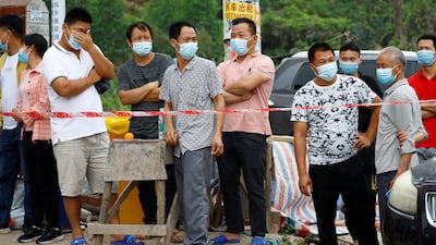 A crowd gathers at a security cordon at the entrance of Lu village, near the site of the crash. Reuters