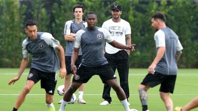 Inter Miami co-owner David Beckham, rear right, watches with his son Cruz, rear left, as midfielder Sergio Busquets, left, and forward Lionel Messi, right, do drills during practice. AP Photo